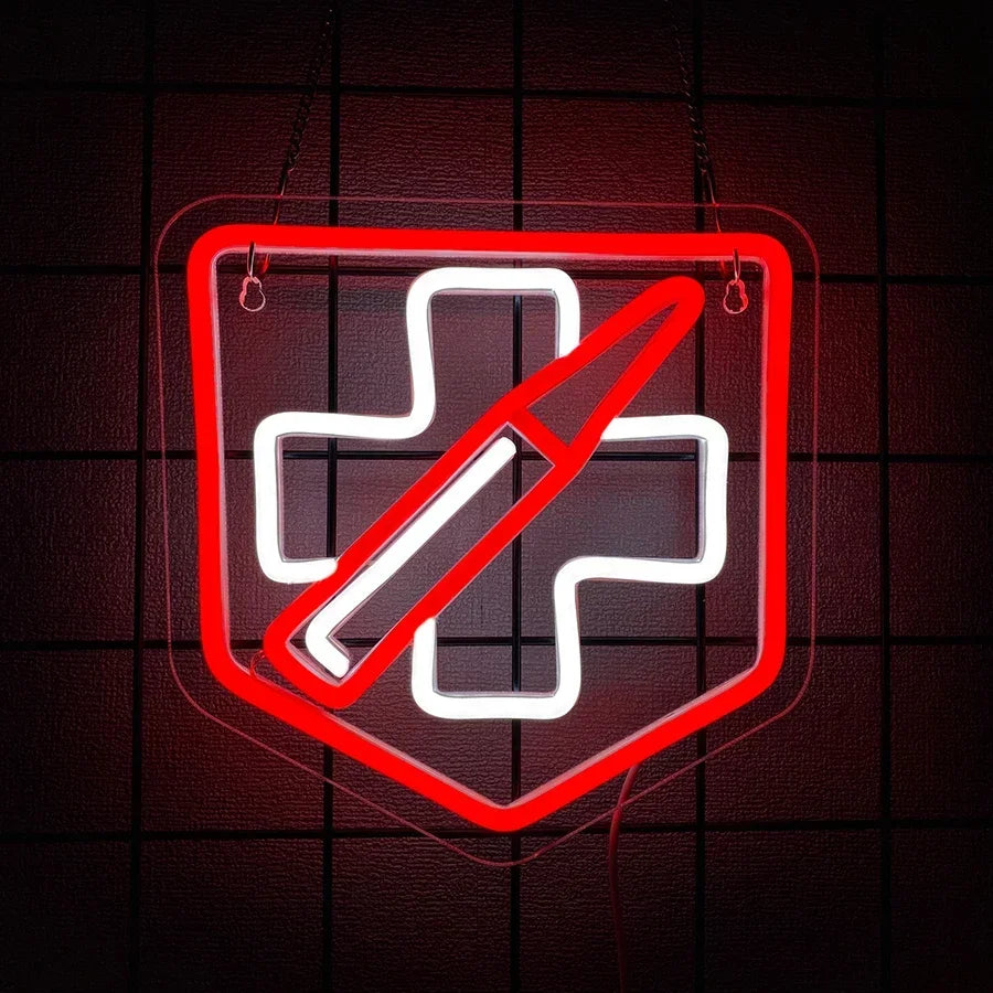 Red and white neon sign of the Call of Duty Zombies Juggernog perk logo - a shield with a cross and diagonal slash - mounted on a dark brick wall